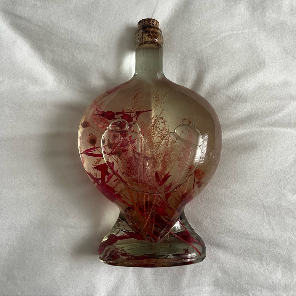 Large decorative heart glass bottle of bath oil